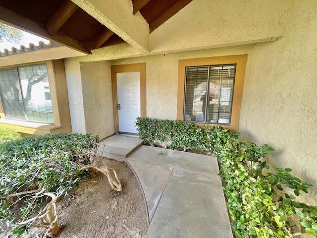 entrance to property with stucco siding