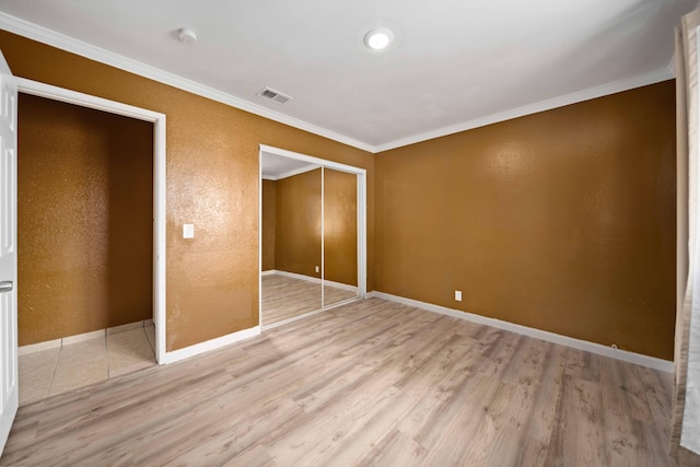 40103 E 169th St, Palmdale, CA 93591 - unfurnished bedroom with light wood-style flooring, ornamental molding, baseboards, and a closet
