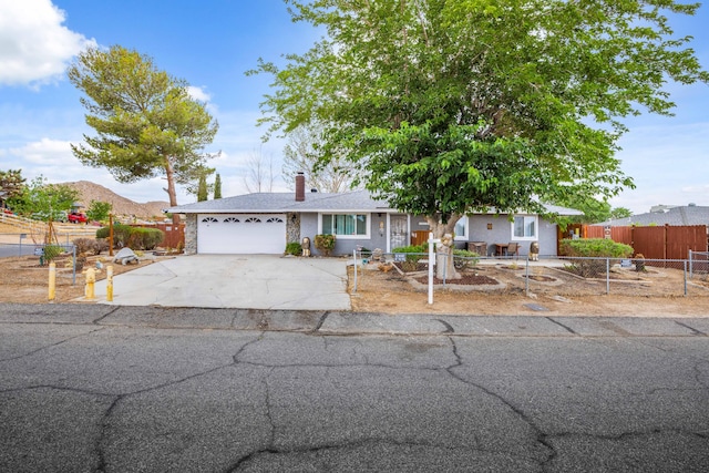 40103 E 169th St, Palmdale, CA 93591 - view of front of home featuring a chimney, driveway, and an attached garage