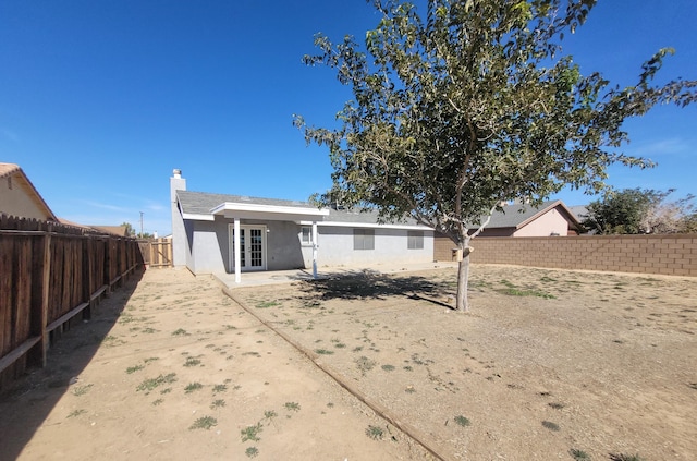 rear view of property with french doors