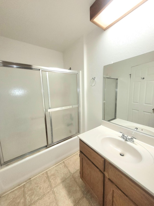 bathroom featuring tile patterned floors, vanity, and shower / bath combination with glass door