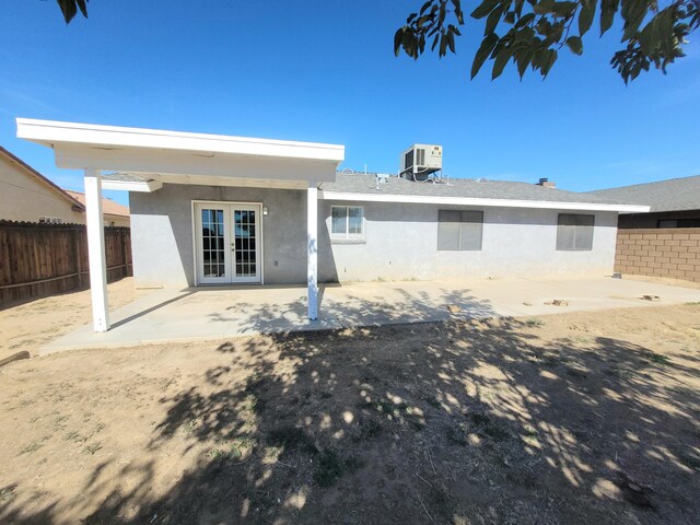 rear view of house with central air condition unit, a patio, and french doors