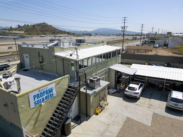 10615 San Fernando Rd, Pacoima, CA 91331 - view of building exterior with a mountain view, stairs, and central air condition unit