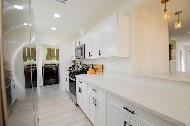 45522 Andale Ave, Lancaster, CA 93535 - kitchen featuring washer / dryer, stainless steel appliances, light stone counters, white cabinets, and recessed lighting