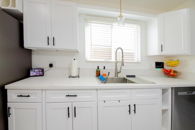 45522 Andale Ave, Lancaster, CA 93535 - kitchen featuring dishwasher, a sink, white cabinetry, and hanging light fixtures