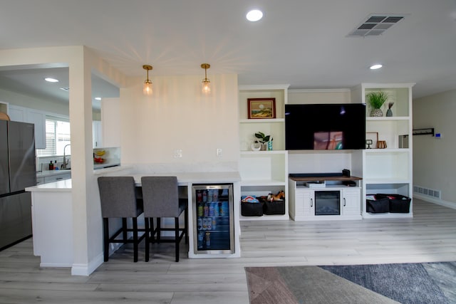 45522 Andale Ave, Lancaster, CA 93535 - living area featuring beverage cooler, light wood-style flooring, recessed lighting, and baseboards