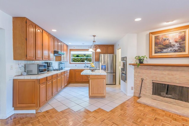 22437 Haynes St, West Hills, CA 91307 - kitchen featuring tile countertops, a center island, decorative backsplash, a warming drawer, and stainless steel appliances