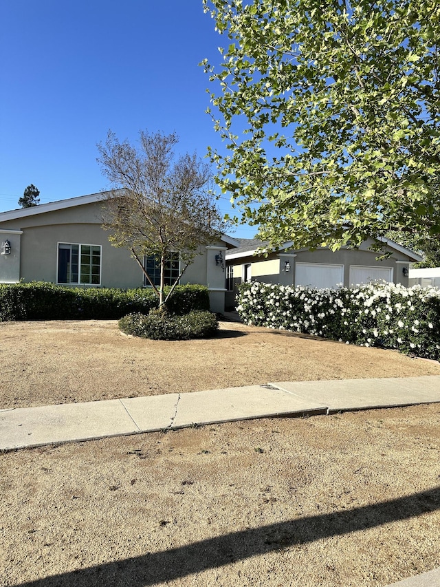 view of front of property featuring a garage and stucco siding