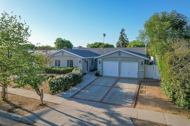 22437 Haynes St, West Hills, CA 91307 - ranch-style house featuring driveway, stucco siding, and a garage