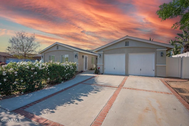 22437 Haynes St, West Hills, CA 91307 - view of front of home with stucco siding, driveway, and a garage
