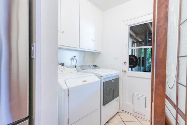 22437 Haynes St, West Hills, CA 91307 - washroom featuring light tile patterned floors, washer and dryer, and cabinet space