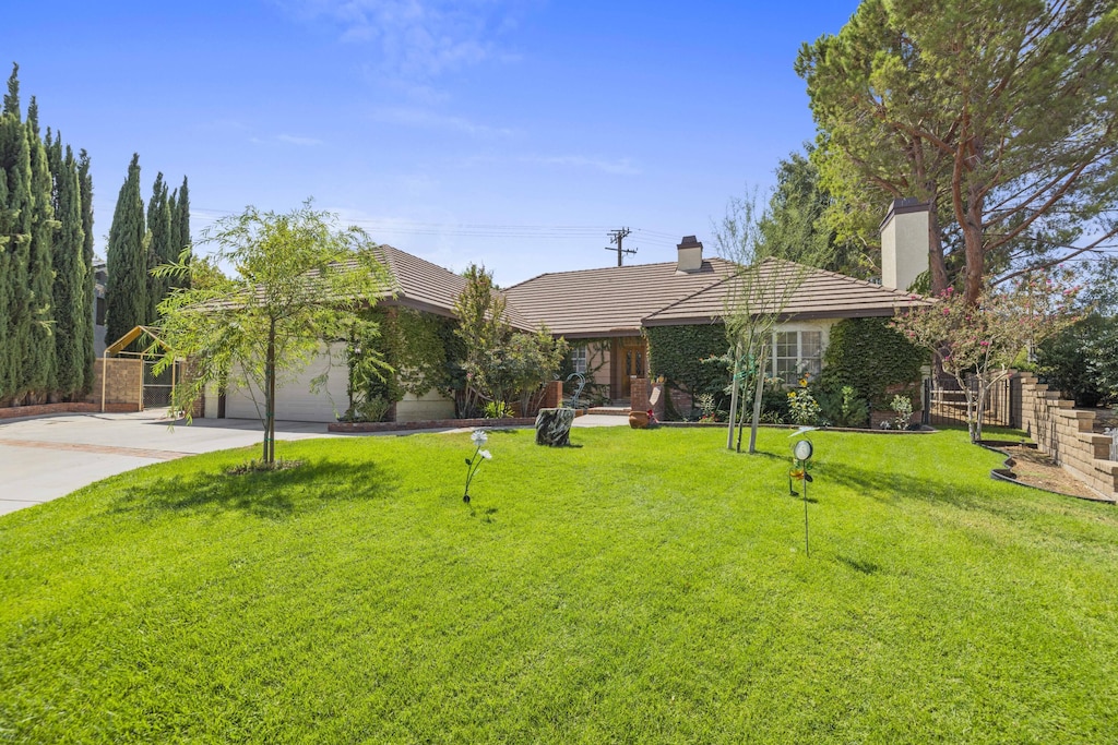 view of front of house with a garage and a front yard