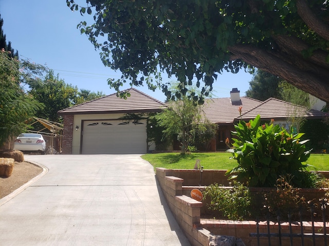 view of front of house with a garage and a front lawn