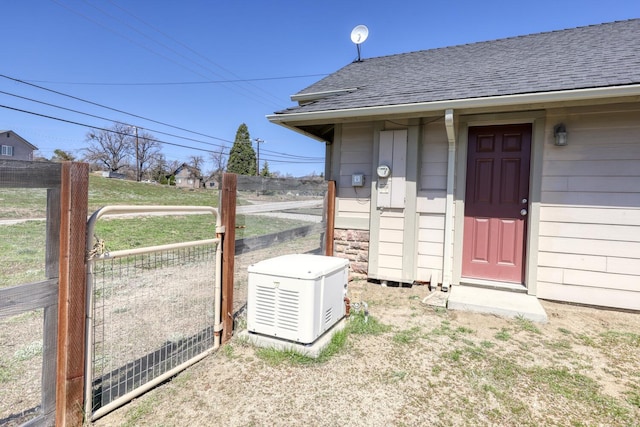 24500 Jacaranda Dr, Tehachapi, CA 93561 - view of exterior entry featuring roof with shingles and fence
