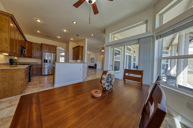 24500 Jacaranda Dr, Tehachapi, CA 93561 - dining area with ceiling fan, healthy amount of natural light, light tile patterned flooring, recessed lighting, and arched walkways