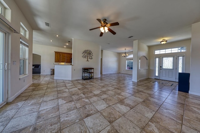 24500 Jacaranda Dr, Tehachapi, CA 93561 - unfurnished living room featuring ceiling fan, a chandelier, baseboards, recessed lighting, and light stone finish flooring