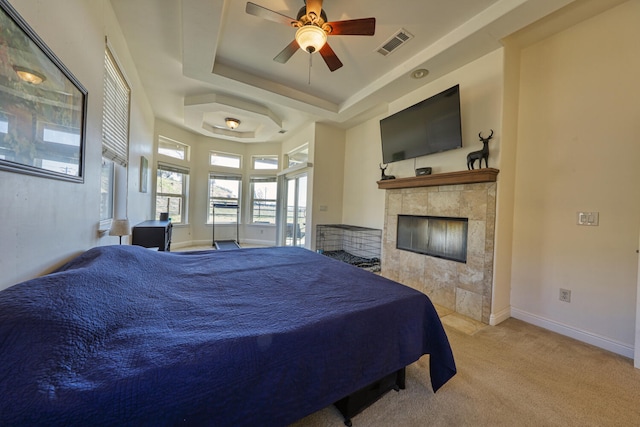 24500 Jacaranda Dr, Tehachapi, CA 93561 - bedroom with carpet, a raised ceiling, a tile fireplace, baseboards, and a ceiling fan