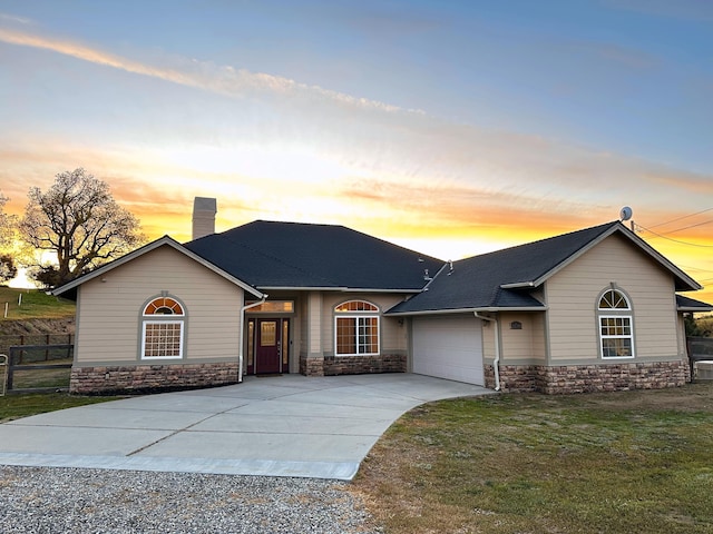 24500 Jacaranda Dr, Tehachapi, CA 93561 - single story home featuring driveway, an attached garage, stone siding, and a chimney