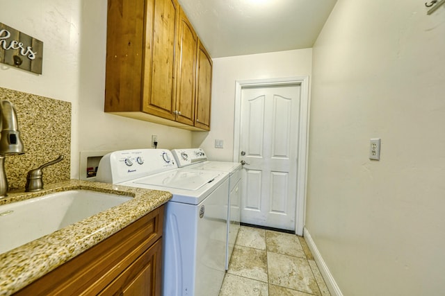 24500 Jacaranda Dr, Tehachapi, CA 93561 - laundry room featuring cabinet space, independent washer and dryer, baseboards, and light stone finish flooring
