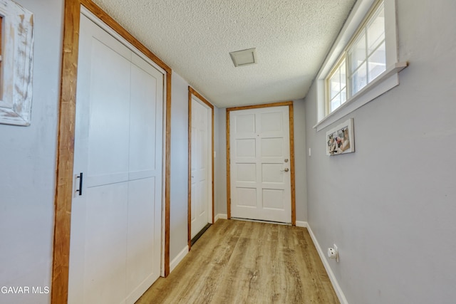 20412 El Porto Ct, Tehachapi, CA 93561 - doorway featuring a textured ceiling and light wood finished floors