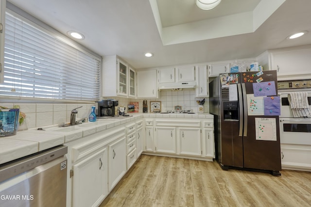 20412 El Porto Ct, Tehachapi, CA 93561 - kitchen featuring tile countertops, appliances with stainless steel finishes, white cabinets, tasteful backsplash, and recessed lighting
