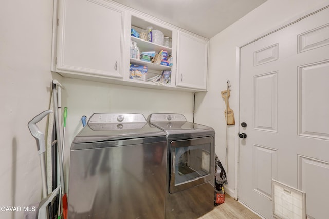 20412 El Porto Ct, Tehachapi, CA 93561 - laundry room featuring cabinet space, washer and clothes dryer, and light wood finished floors