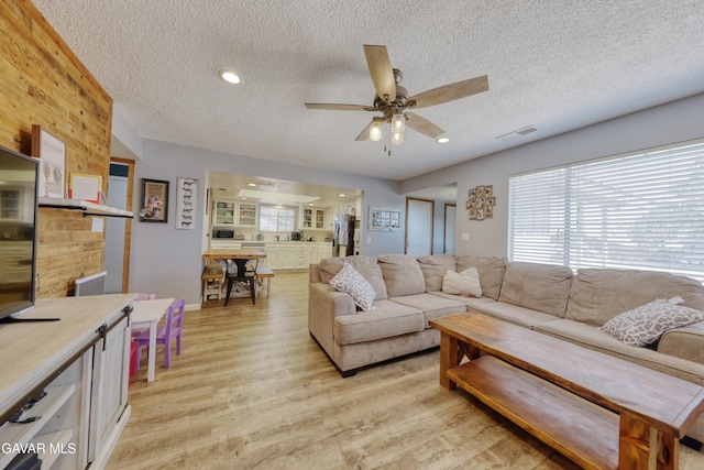 20412 El Porto Ct, Tehachapi, CA 93561 - living room featuring a textured ceiling, light wood finished floors, a ceiling fan, and recessed lighting
