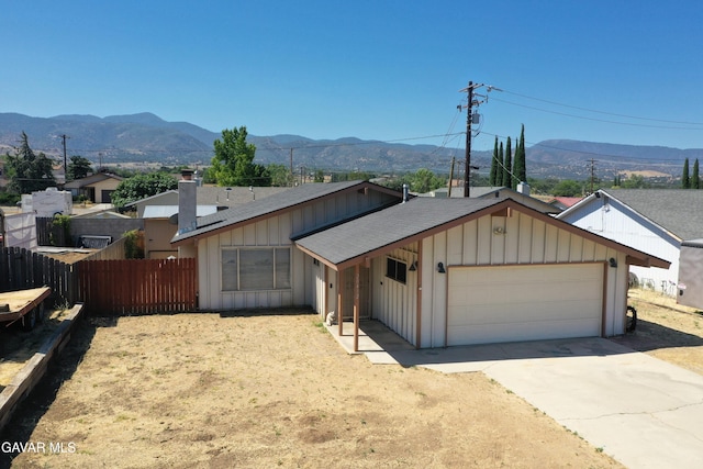 20412 El Porto Ct, Tehachapi, CA 93561 - view of front of house featuring roof with shingles, board and batten siding, a mountain view, and an attached garage