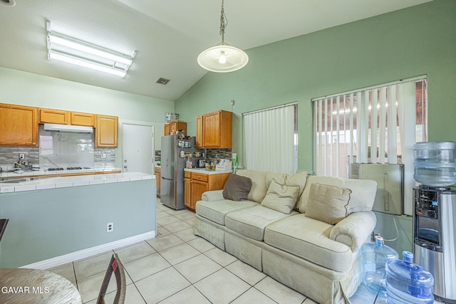 6019 Diamond St, Palmdale, CA 93552 - living room featuring light tile patterned flooring and vaulted ceiling