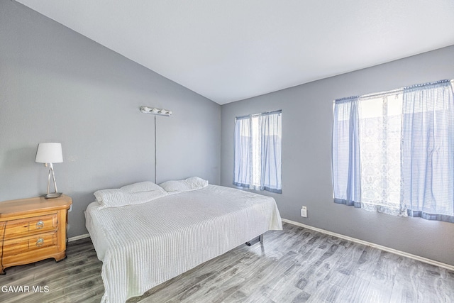6019 Diamond St, Palmdale, CA 93552 - bedroom with vaulted ceiling and wood finished floors