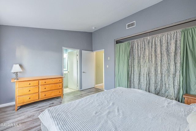 6019 Diamond St, Palmdale, CA 93552 - bedroom featuring lofted ceiling, light wood finished floors, and ensuite bathroom