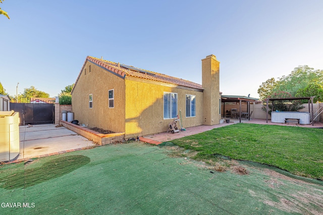 6019 Diamond St, Palmdale, CA 93552 - rear view of house with a hot tub, a patio area, a fenced backyard, a chimney, and stucco siding