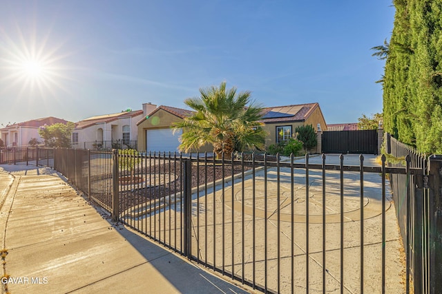 6019 Diamond St, Palmdale, CA 93552 - view of front of house featuring solar panels, a garage, a residential view, and concrete driveway