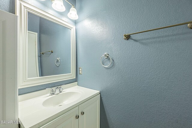 6019 Diamond St, Palmdale, CA 93552 - bathroom featuring a textured wall and vanity