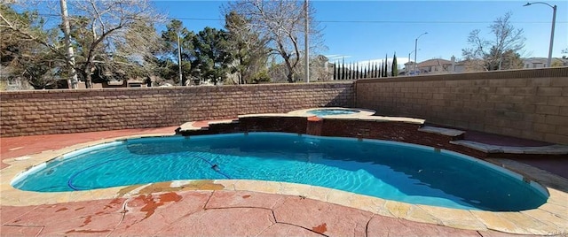 view of swimming pool featuring an in ground hot tub