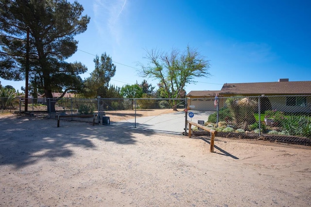 view of street featuring a gate, a gated entry, and driveway