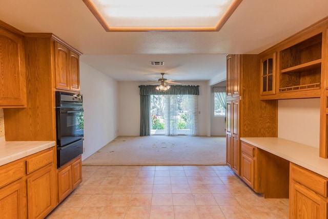 kitchen featuring ceiling fan, visible vents, a warming drawer, light carpet, and oven