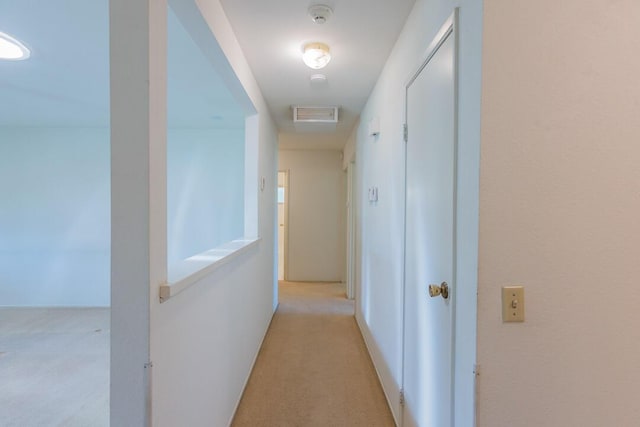 corridor featuring light carpet and visible vents