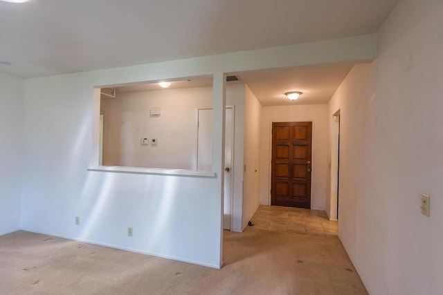 hallway with carpet floors
