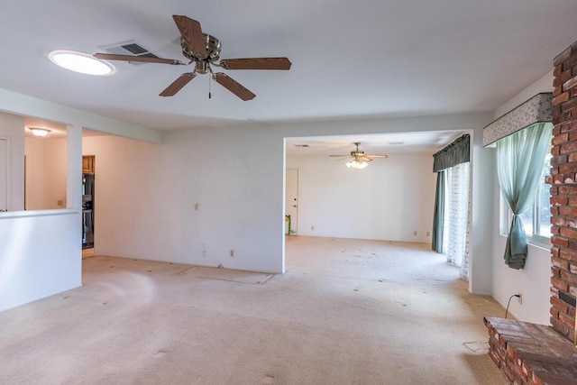 unfurnished living room with light colored carpet, a ceiling fan, and visible vents