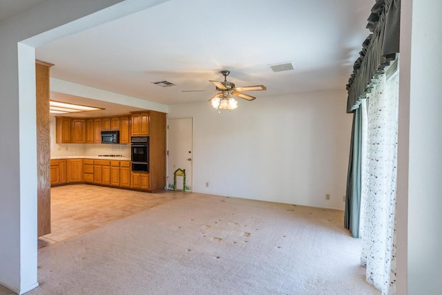 kitchen featuring a ceiling fan, visible vents, light countertops, black appliances, and light carpet