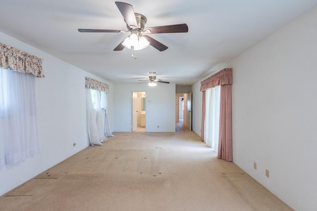 empty room with light colored carpet and ceiling fan