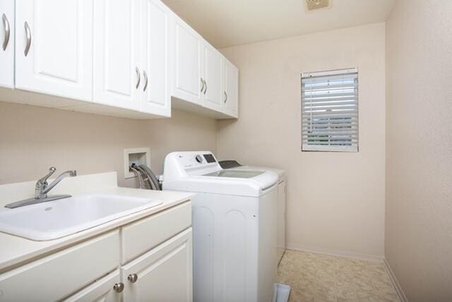 2447 Brompton Ct, Palmdale, CA 93551 - laundry area with cabinet space, washer and clothes dryer, and baseboards