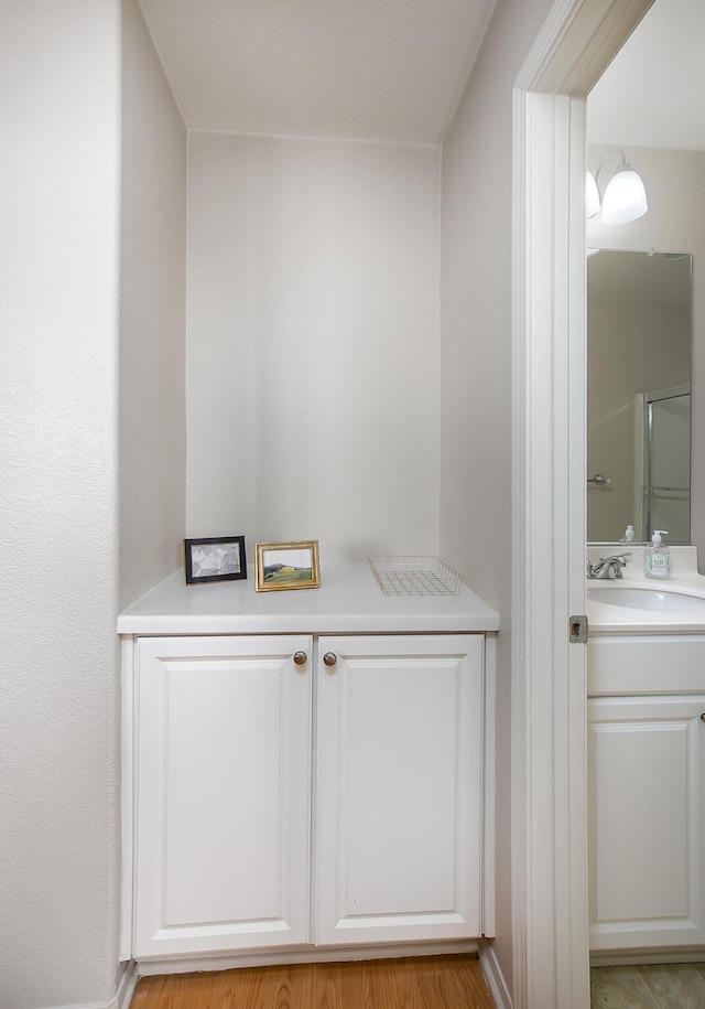 2447 Brompton Ct, Palmdale, CA 93551 - bathroom view of vanity and a shower with door