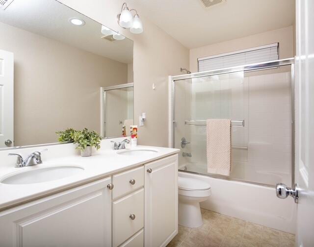 2447 Brompton Ct, Palmdale, CA 93551 - bathroom featuring toilet, double vanity, shower / bath combination with glass door, and recessed lighting