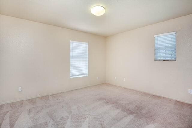 2447 Brompton Ct, Palmdale, CA 93551 - unfurnished room with healthy amount of natural light and light carpet