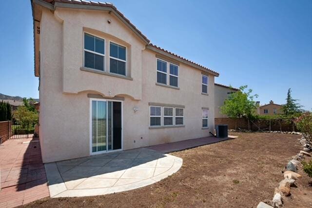 2447 Brompton Ct, Palmdale, CA 93551 - back of house with stucco siding, a patio, and central AC