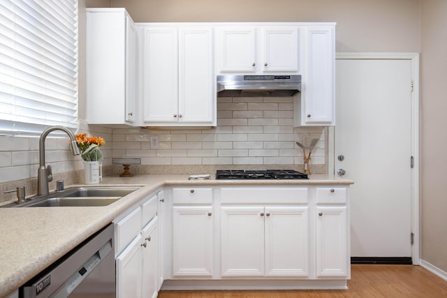 2447 Brompton Ct, Palmdale, CA 93551 - kitchen with a sink, dishwasher, ventilation hood, decorative backsplash, and white cabinets