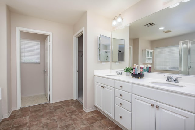 2447 Brompton Ct, Palmdale, CA 93551 - bathroom with double vanity, baseboards, and a shower with shower door