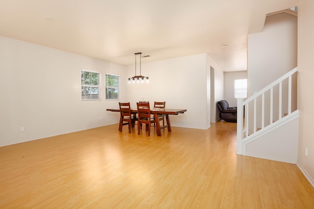 2447 Brompton Ct, Palmdale, CA 93551 - dining space with plenty of natural light, light wood-style floors, stairway, and baseboards